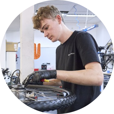 Ben from EBT fixing a bike wheel