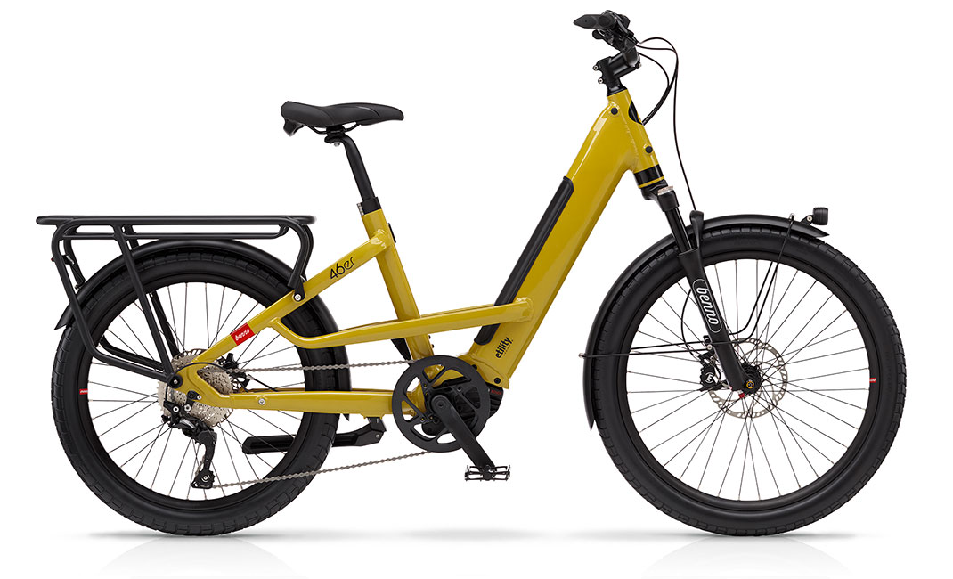 A yellow Benno 46er electric cargo bike with unequal wheels, front suspension, and a rear cargo rack.