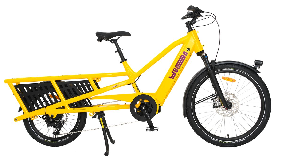 Yellow Yuba Spicy Curry V4 e-cargo bike with black seat and wheels on a white background